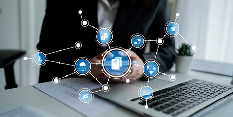 A business professional sits at a modern office desk, using a smartphone surrounded by technology icons representing digital communication and innovative solutions. Crux