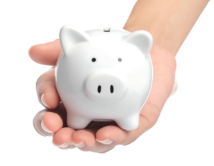 A close-up shot of a human hand delicately holding a small, glossy white ceramic piggy bank against a black backdrop