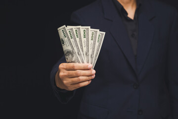 Businessman holding cash money for financial success concept.