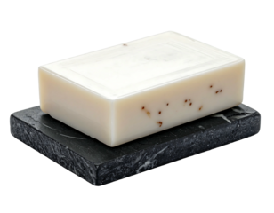 A close-up shot of a rectangular bar resting on a textured, dark gray soap dish. The soap has subtle specks