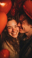 Happy couple smiling and embracing among red heart balloons, during Valentine's day, vertical photo