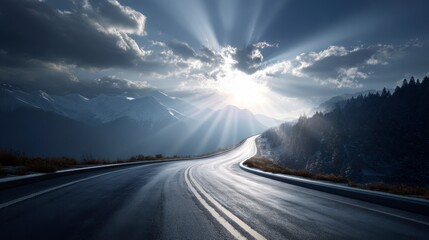 A winding highway curves through a mountain range. The sun bursts through storm clouds, casting a light show
