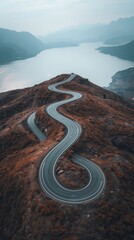Serpentine mountain road overlooking calm lake