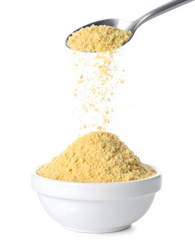 Breadcrumbs Cascading from Spoon into White Dish Isolated on White
