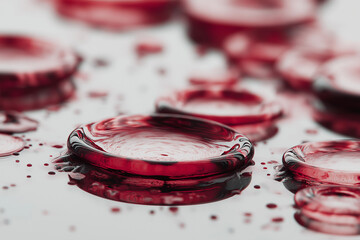 Abstract Close-Up of Circular Red Wine Stains and Liquid Rings on a Reflective Mirror Surface