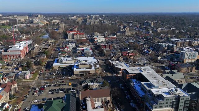 Wide drone view of Bloomington Indiana with residential streets and university area in winter daylight 
