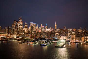 New York City panoramic skyline. New York panoramic cityscape. Lower Manhattan aerial view. New York night metropolis. NYC skyline with Hudson landscape. NYC skyscrapers at night, panoramic skyline.