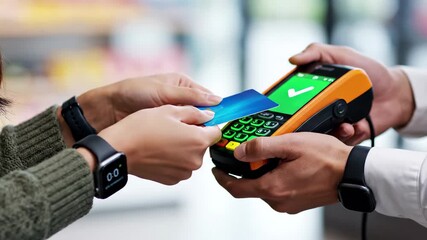 Customer making contactless payment with credit card at point of sale terminal held by cashier, 4k high quality video - Powered by Adobe