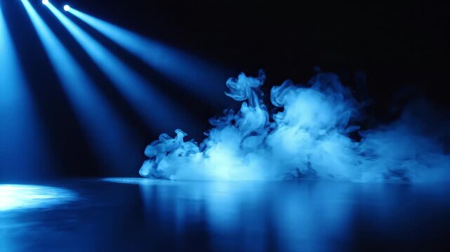 Blue stage spotlights beaming through low lying smoke and fog on dark reflective floor, 4k high quality video