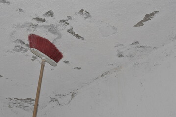 Wall preparation: Deep cleaning surfaces and ceilings with a broom before painting in home renovation project