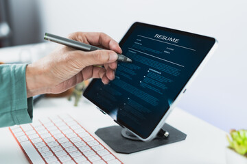 Reviewing digital resume on tablet with pen