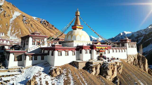 Key monastery kye gompa in spiti valley, himachal pradesh, india, with prayer flags and snowcapped mountains under a bright blue sky, 4k high quality video