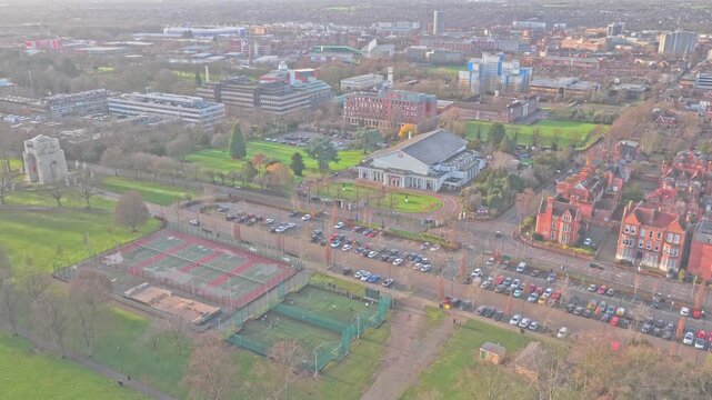 Vibrant panorama of Victoria Park, Leicester, where the solemnity of Lutyens' Cenotaph meets the active energy of modern sports hubs against a classic English red-brick skyline, England.