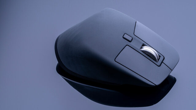 Modern professional computer mouse for designers on a black background with reflection. Professional studio photo of a computer mouse. High quality photo
