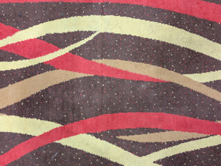 Abstract Carpet Pattern with Curved Red and Cream Stripes on Brown Background

