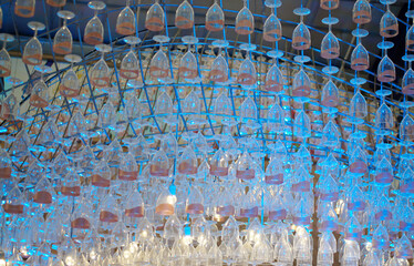 Ceiling decoration, Wine glass hang with structure and blue color lighting decorate ceiling at mall