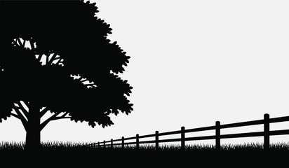 A striking silhouette of a large tree and a rustic wooden fence stretching into the distance creating a peaceful scene © Thysl2000