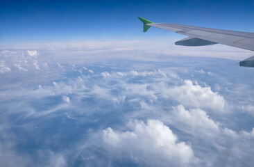 Aerial view of soft white cumulus clouds seen from the plane