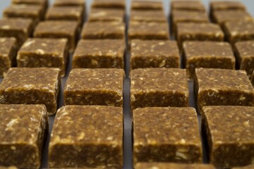 Close up of neatly arranged emergency ration bars showcasing survival food options for outdoor adventures and preparedness in a survival situation