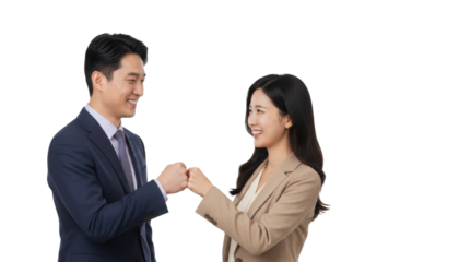 Successful Asian business team bump fists in celebration of teamwork and collaboration achievement award