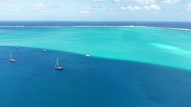 French Polynesia, Panoramic Drone Shot of Turquoise Lagoon Water and Sailboats Near Island Coastline