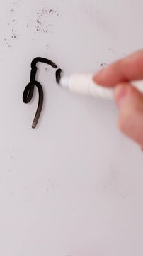 A hand writes the markdown percentage on a surface using a marker. The writing shows a deal and highlights the savings available. Check out these great offers for a limited time.