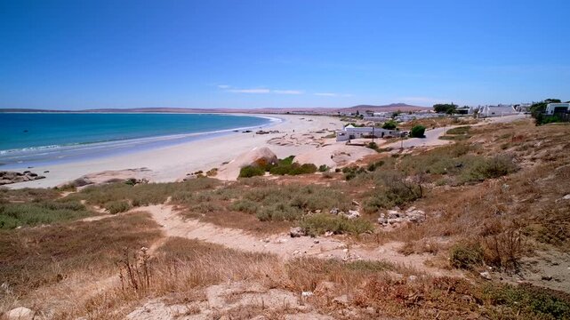 Scenic stretch of beach and turquoise Cape West Coast ocean in Paternoster