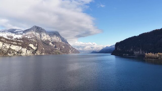 calm walensee lake surrounded by the swiss alps under clear winter light