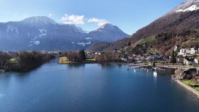 clear walensee waters beside alpine village in the swiss alps