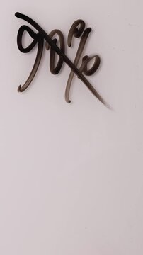 A hand uses a marker to erase and change a sign showing 90 percent off to read 10 percent off. This marks a change in a discount for a limited-time offer.
