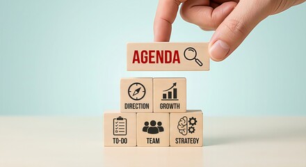 Business agenda and strategic management concept with businessman hand placing AGENDA block on top of pyramid featuring team, growth, direction, strategy and to-do list icons, symbolizing efficient me