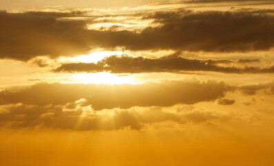 The sun is shining through the clouds