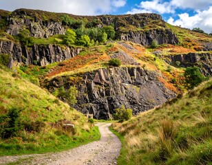 A winding dirt path leads into a rugged, mountainous landscape