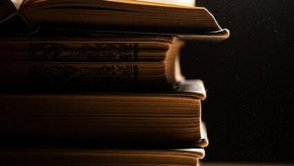 Literary Stacks: A collection of vintage books piled high, with their aged pages and worn covers creating a sense of history and wisdom.