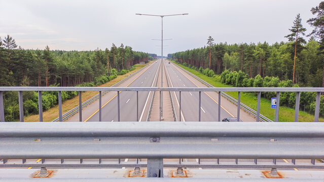 Russia. The M11 highway with cars moving along it. Aerial view from the overpass
