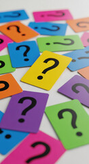 Scattered, colorful cards display question mark, symbolizing uncertainty, curiosity, and problem-solving, on a white surface, idea for education concept