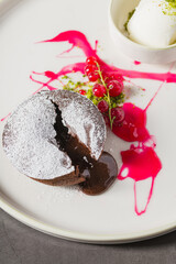 Warm chocolate lava cake with flowing center and powdered sugar