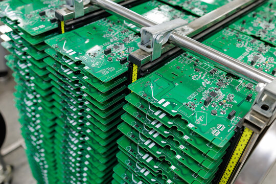 Stacked printed circuit boards in automated SMT manufacturing line