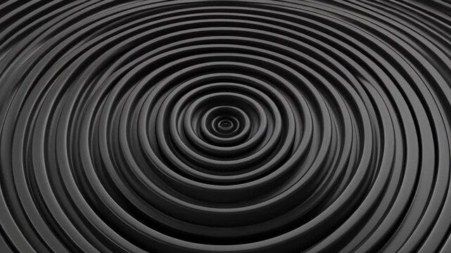 Abstract dark grey concentric ripples creating a hypnotic visual effect.