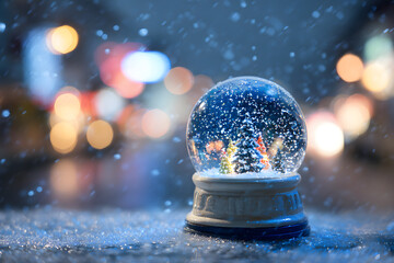 christmas snow globe at night with soft blue defocused background creating a magical wish mood