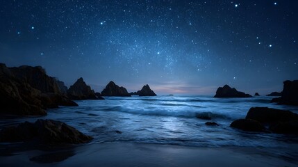 Starry night sky over a serene ocean coastline with gentle waves and dramatic rock formations