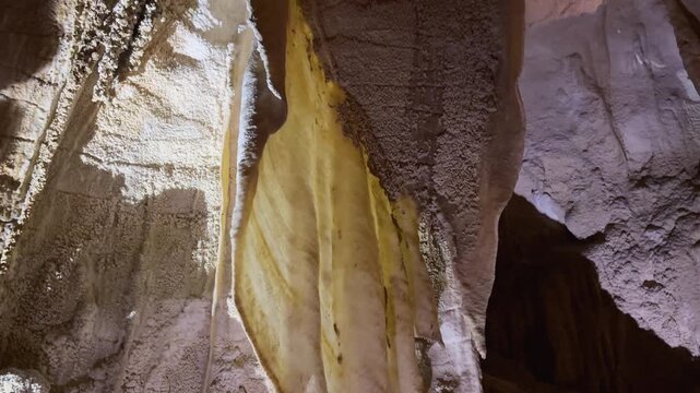 Delicate cave curtains formed inside the Waitomo Caves in New Zealand&rsquo;s North Island. Thin mineral sheets hang from the cave walls, creating striking natural underground formations.