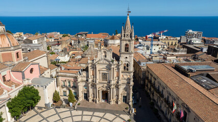 Obraz premium Aerial view of the Basilica of Saints Peter and Paul in Acireale. It is a Baroque-style Roman Catholic collegiate church located in Sicily, Italy. The Mediterranean Sea is visible on the horizon.
