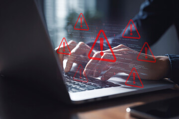 Cybersecurity Alert: Hands Typing on Laptop with Overlay of Code and Multiple Red Warning Signs Indicating System Error or Data Breach Threat