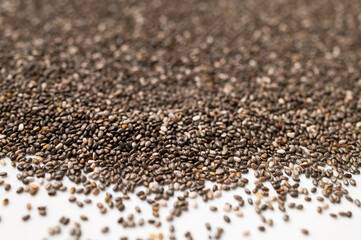 Chia seeds macro, texture. Food background, healthy eating concept, superfood. Dry organic chia seeds rich in omega-3, protein, vitamins and minerals. Chia seeds close up
