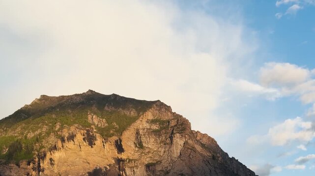 4K Landscape shot of Himalayan mountain peak during the sunset with clouds above it as seen from Killar town in Chamba district, Himachal Pradesh, India. Scenic view of mountain during sunset.