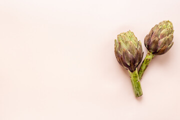 Whole heads of purple artichokes top view. Vegetables food ready to cook