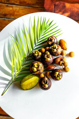 Set of fresh tropical fruit mangosteen on white table. Healthy vegetarian food