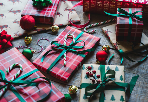 Close up of Christmas gifts wrapped in red and green with ribbons.