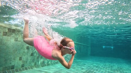 Underwater swimming session of a child in a pool setting